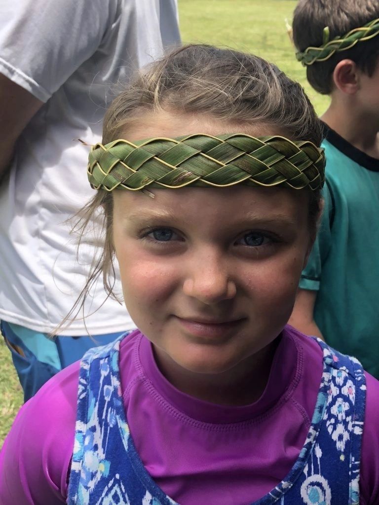 Kids making floral crowns at a Hawaiian luau party
