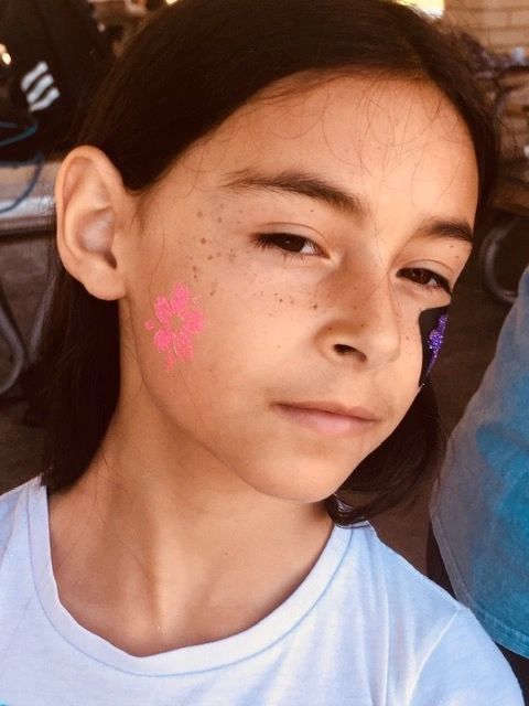 Glitter tattoo artist at a kids party