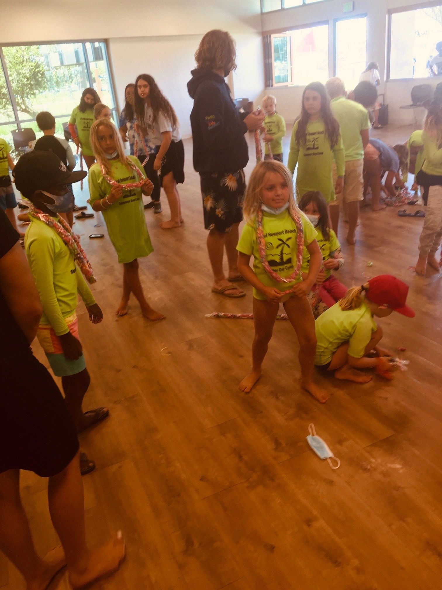 Kids making candy leis at a Hawaiian luau party